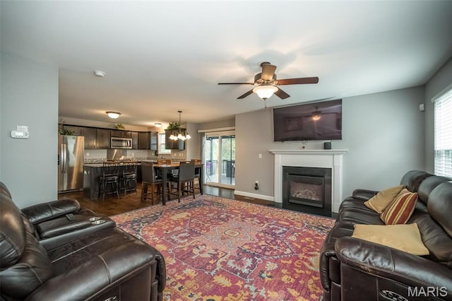 1338 Orchard Lakes Cir, Belleville, IL 62220 - living area with ceiling fan, a chandelier, and a glass covered fireplace