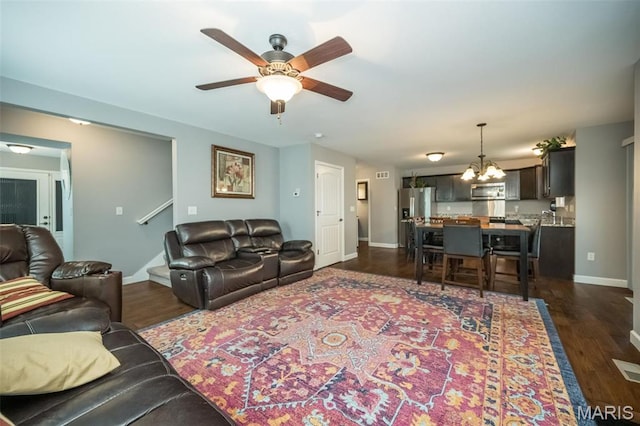 1338 Orchard Lakes Cir, Belleville, IL 62220 - living area with a chandelier, a ceiling fan, dark wood-style flooring, and baseboards