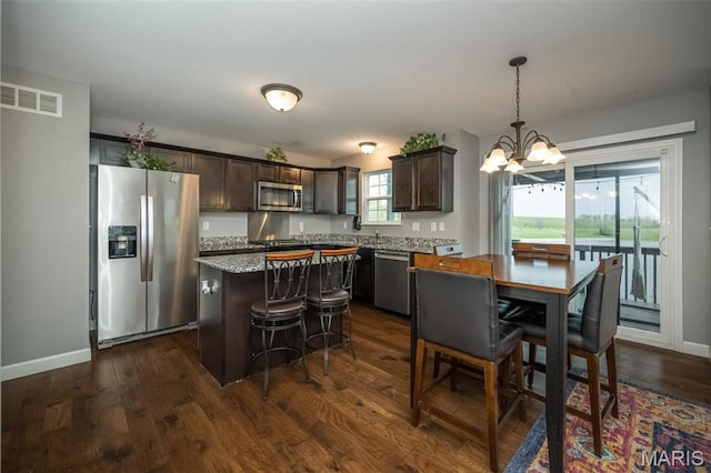 1338 Orchard Lakes Cir, Belleville, IL 62220 - kitchen with appliances with stainless steel finishes, a chandelier, dark brown cabinets, a center island, and dark wood-style flooring