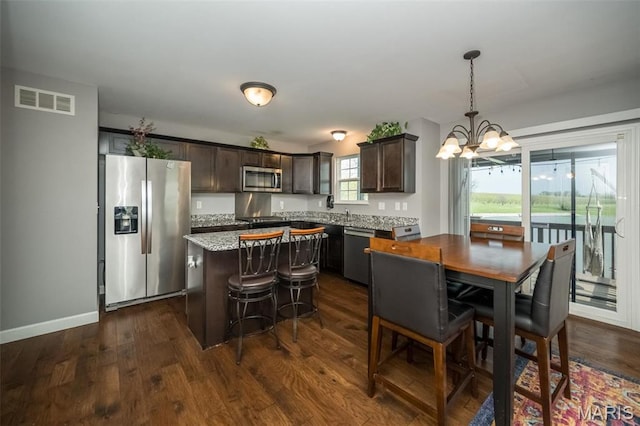 1338 Orchard Lakes Cir, Belleville, IL 62220 - dining space with a chandelier, dark wood-style floors, and baseboards
