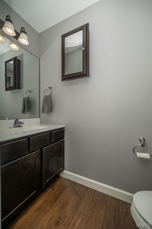 1338 Orchard Lakes Cir, Belleville, IL 62220 - bathroom with wood finished floors, baseboards, toilet, and vanity