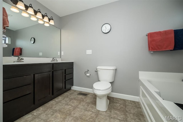 1338 Orchard Lakes Cir, Belleville, IL 62220 - full bathroom with baseboards, toilet, a bathtub, double vanity, and tile patterned floors