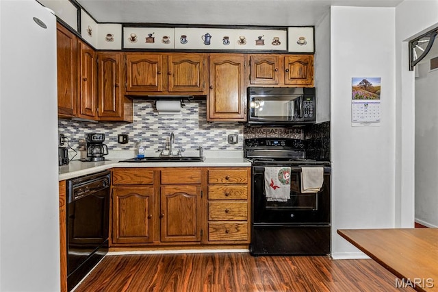 11 Heather Ct, Crystal City, MO 63019 - kitchen with black appliances, a sink, dark wood-type flooring, and light countertops