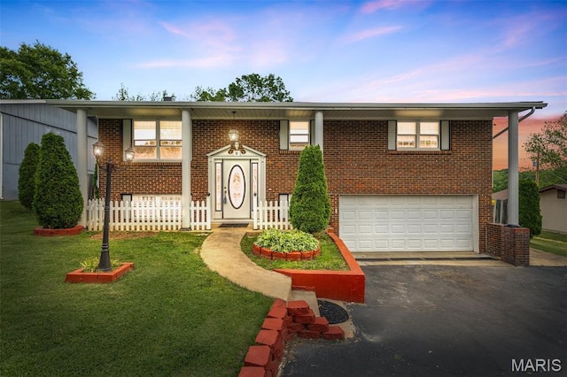 11 Heather Ct, Crystal City, MO 63019 - view of front of home with an attached garage, asphalt driveway, brick siding, a lawn, and a porch