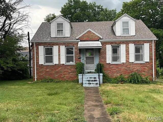 3460 Oakdale Ave, Saint Louis, MO 63121 - cape cod home featuring a front lawn, brick siding, and a shingled roof