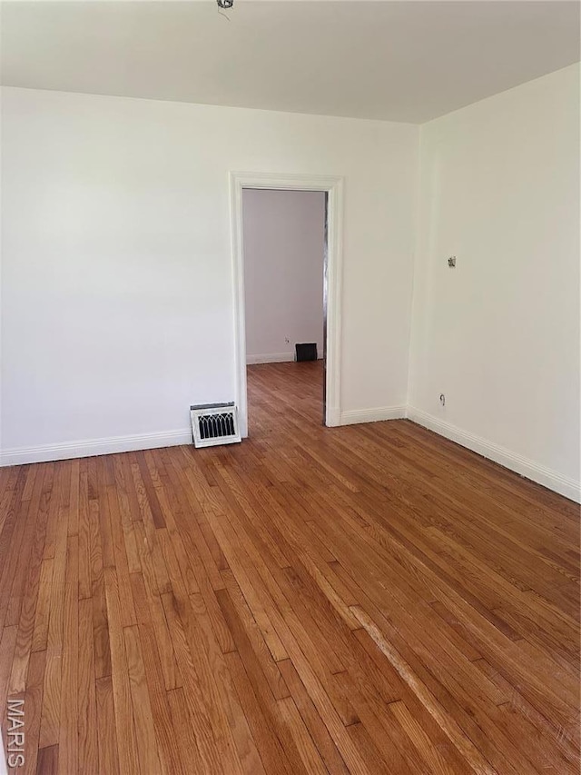 3460 Oakdale Ave, Saint Louis, MO 63121 - unfurnished room with wood-type flooring and baseboards