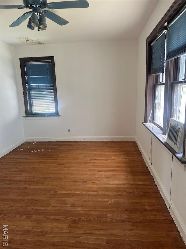 3460 Oakdale Ave, Saint Louis, MO 63121 - spare room with wood finished floors, baseboards, and ceiling fan