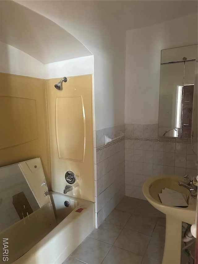 3460 Oakdale Ave, Saint Louis, MO 63121 - full bath featuring tile walls, shower / tub combination, tile patterned floors, and a wainscoted wall