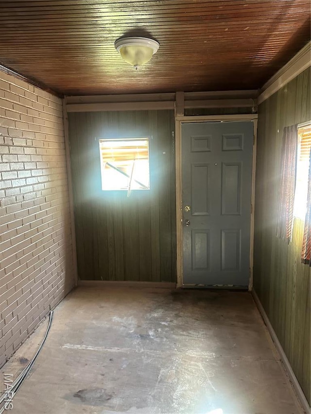 3460 Oakdale Ave, Saint Louis, MO 63121 - foyer with wooden ceiling, wood walls, and brick wall