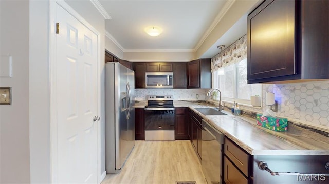 156 Cascade Terrace Dr, Ballwin, MO 63021 - kitchen featuring stainless steel appliances, light wood-style floors, light countertops, backsplash, and ornamental molding