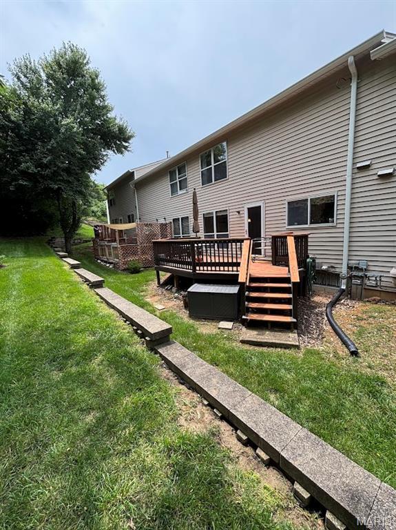 156 Cascade Terrace Dr, Ballwin, MO 63021 - rear view of property featuring a deck and a lawn