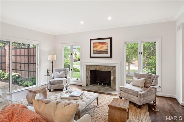 139 N Central Ave Unit P, Saint Louis, MO 63105 - living area with ornamental molding, wood finished floors, a tiled fireplace, and recessed lighting