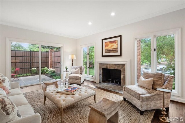 139 N Central Ave Unit P, Saint Louis, MO 63105 - living room featuring ornamental molding, a tile fireplace, wood finished floors, plenty of natural light, and recessed lighting