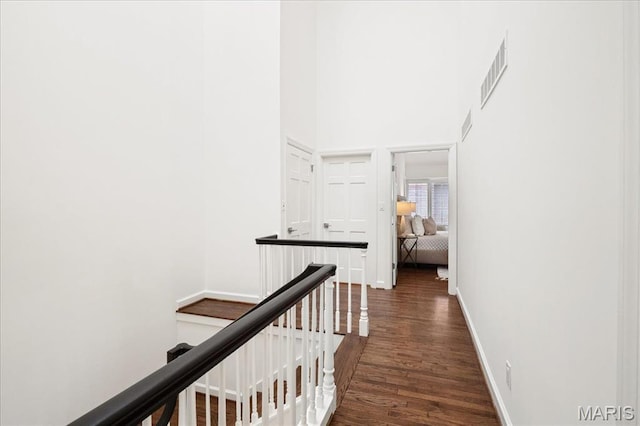 139 N Central Ave Unit P, Saint Louis, MO 63105 - corridor with dark wood finished floors, an upstairs landing, and a towering ceiling