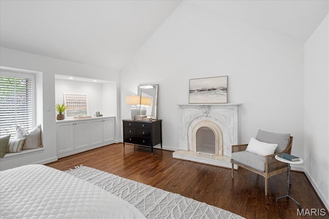 139 N Central Ave Unit P, Saint Louis, MO 63105 - bedroom featuring wood finished floors, high vaulted ceiling, and a premium fireplace