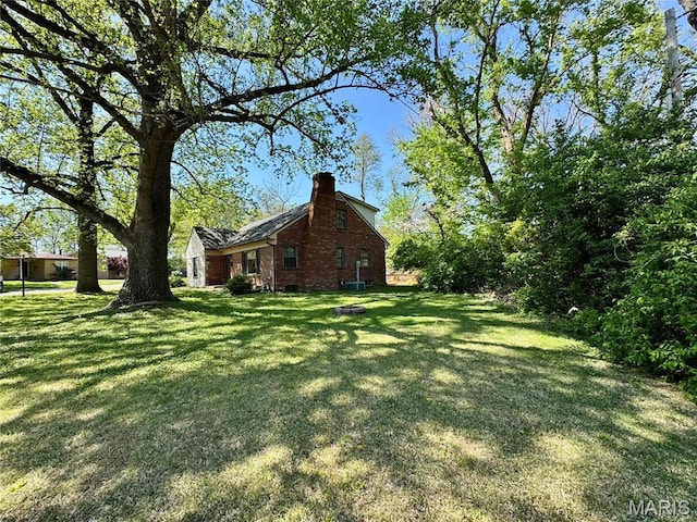 view of green lawn featuring cooling unit