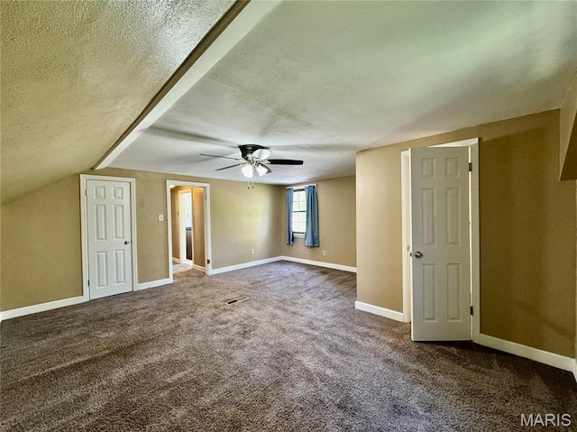 bonus room featuring a textured ceiling, carpet, a ceiling fan, and baseboards