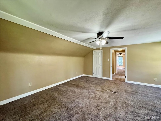 additional living space with ceiling fan, baseboards, carpet flooring, a textured ceiling, and lofted ceiling