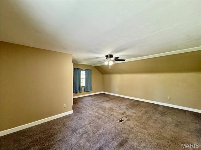 additional living space with a ceiling fan, carpet, baseboards, and lofted ceiling