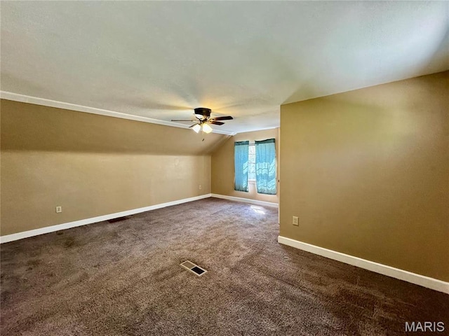 bonus room featuring ceiling fan, lofted ceiling, baseboards, and dark carpet
