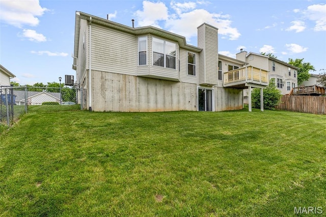 1421 N Woods Dr, Festus, MO 63028 - back of property with a wooden deck, a chimney, and central AC unit