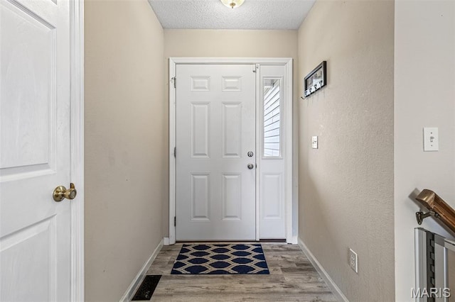 1421 N Woods Dr, Festus, MO 63028 - doorway featuring wood finished floors, a textured ceiling, baseboards, a textured wall, and wine cooler