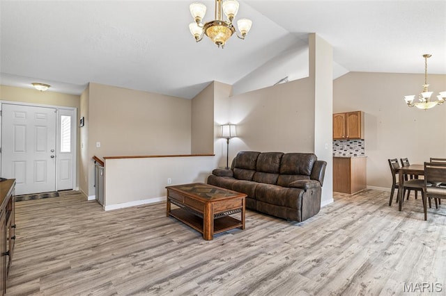 1421 N Woods Dr, Festus, MO 63028 - living area with a chandelier, light wood-type flooring, vaulted ceiling, and baseboards