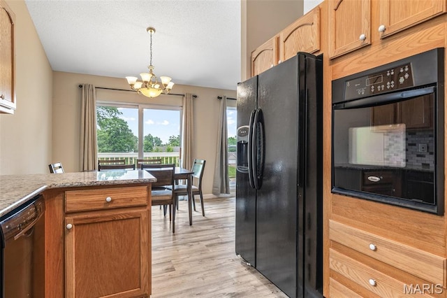 1421 N Woods Dr, Festus, MO 63028 - kitchen featuring black appliances, a chandelier, healthy amount of natural light, and light wood-type flooring