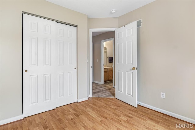 1421 N Woods Dr, Festus, MO 63028 - unfurnished bedroom with light wood-style floors, baseboards, and a closet