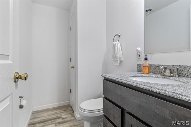 1421 N Woods Dr, Festus, MO 63028 - bathroom with vanity, toilet, wood finished floors, and baseboards