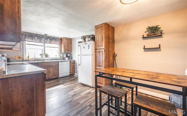 10771 Crest Rd, Dixon, MO 65459 - kitchen featuring white appliances, dark wood-style flooring, and brown cabinetry