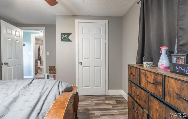 10771 Crest Rd, Dixon, MO 65459 - bedroom with dark wood-style floors, baseboards, and connected bathroom