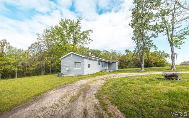 10771 Crest Rd, Dixon, MO 65459 - view of front of property featuring a fire pit, driveway, and a front yard