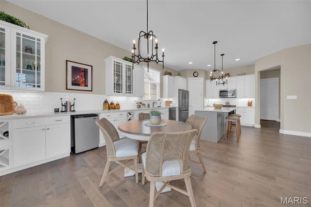 501 Upper Ridgepointe Ct, Lake St Louis, MO 63367 - dining room featuring a chandelier, wood finished floors, and recessed lighting