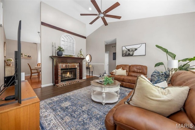 611 Woodchuck Ln, Lake St Louis, MO 63367 - living area with ceiling fan, wood finished floors, vaulted ceiling, baseboards, and a brick fireplace