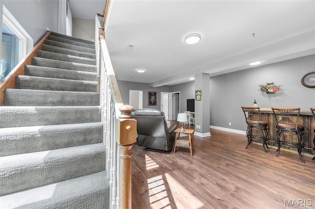611 Woodchuck Ln, Lake St Louis, MO 63367 - stairs featuring wood finished floors, a dry bar, and baseboards