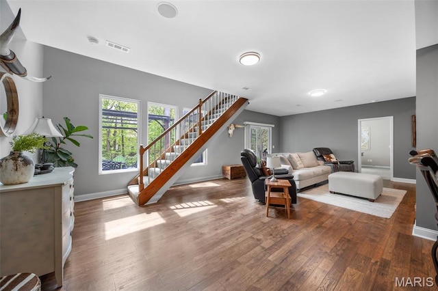 611 Woodchuck Ln, Lake St Louis, MO 63367 - living room featuring wood finished floors, stairway, baseboards, and plenty of natural light