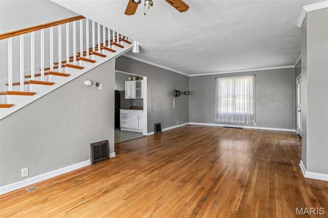 323 N Division St, Bonne Terre, MO 63628 - unfurnished living room with ornamental molding, hardwood / wood-style flooring, ceiling fan, a textured ceiling, and baseboards