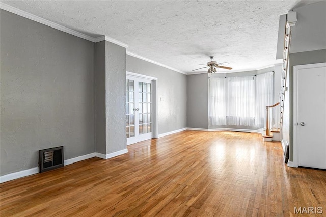 323 N Division St, Bonne Terre, MO 63628 - unfurnished living room featuring plenty of natural light, a textured wall, ceiling fan, wood finished floors, and a textured ceiling