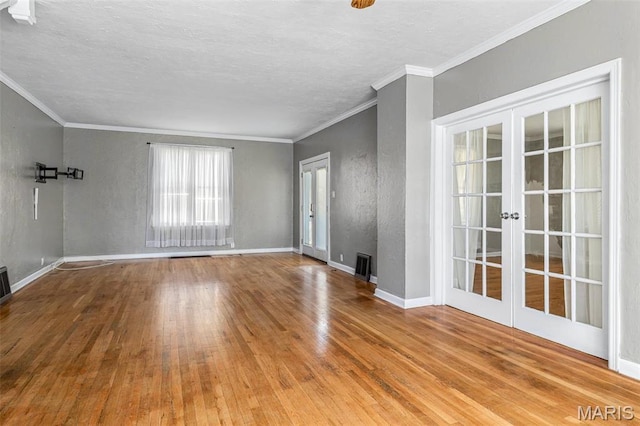 323 N Division St, Bonne Terre, MO 63628 - unfurnished living room featuring wood finished floors, french doors, crown molding, baseboards, and a textured ceiling