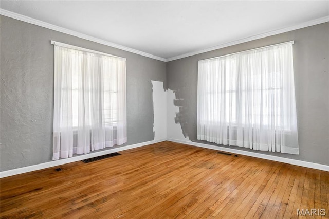 323 N Division St, Bonne Terre, MO 63628 - unfurnished room with healthy amount of natural light, hardwood / wood-style floors, ornamental molding, baseboards, and a textured wall