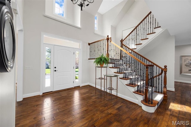 1264 Wilton Ln, Saint Louis, MO 63122 - foyer entrance featuring wood-type flooring, a towering ceiling, stairs, a chandelier, and baseboards
