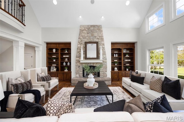 1264 Wilton Ln, Saint Louis, MO 63122 - living room with high vaulted ceiling, wood finished floors, ornate columns, and a stone fireplace