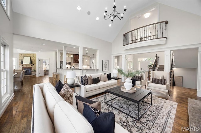 1264 Wilton Ln, Saint Louis, MO 63122 - living room with high vaulted ceiling, a chandelier, hardwood / wood-style floors, a fireplace, and recessed lighting
