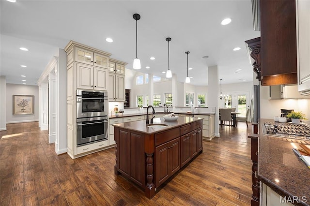 1264 Wilton Ln, Saint Louis, MO 63122 - kitchen with double oven, an island with sink, dark wood-style flooring, a sink, and recessed lighting