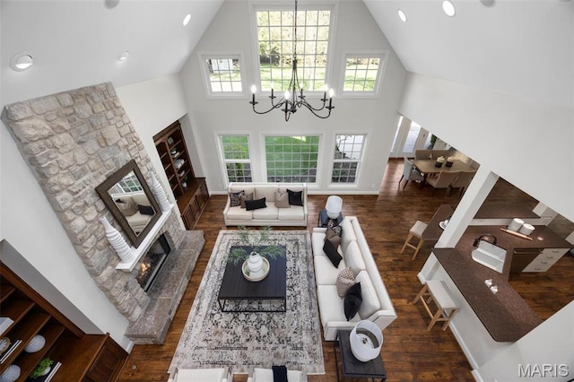 1264 Wilton Ln, Saint Louis, MO 63122 - living area featuring a fireplace, high vaulted ceiling, wood finished floors, and a chandelier