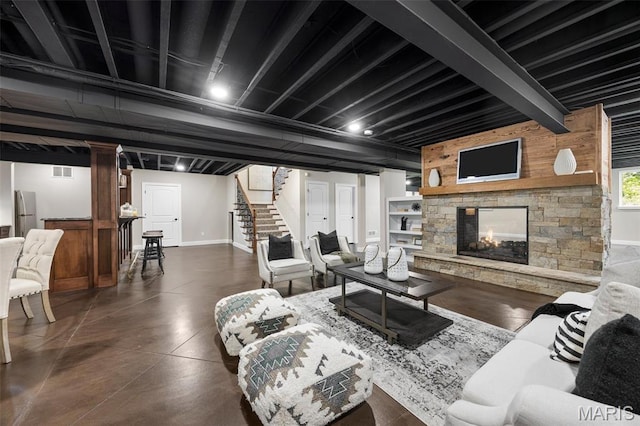 1264 Wilton Ln, Saint Louis, MO 63122 - living room featuring stairs, concrete flooring, baseboards, and a stone fireplace
