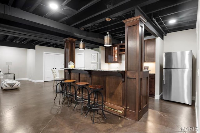 1264 Wilton Ln, Saint Louis, MO 63122 - indoor wet bar featuring freestanding refrigerator, finished concrete floors, baseboards, and decorative light fixtures