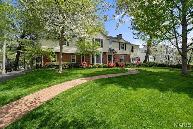 133 Webster Woods Dr, Saint Louis, MO 63119 - view of front of property with brick siding, a chimney, and a front yard