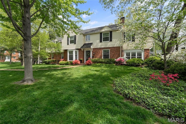 133 Webster Woods Dr, Saint Louis, MO 63119 - traditional home with brick siding, a chimney, and a front yard